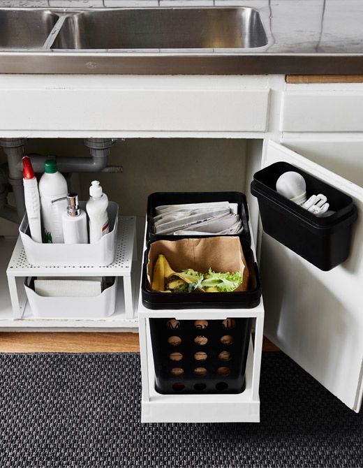 the kitchen sink is full of cleaning supplies