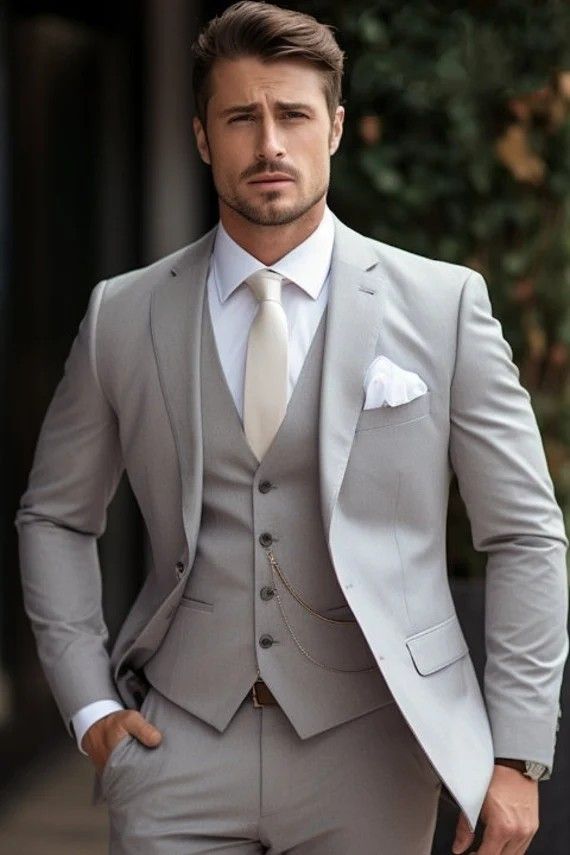 a man in a gray suit and white shirt