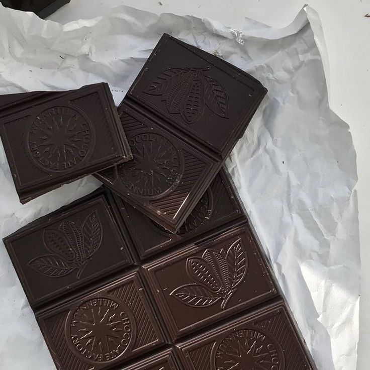 four pieces of chocolate sitting on top of white paper