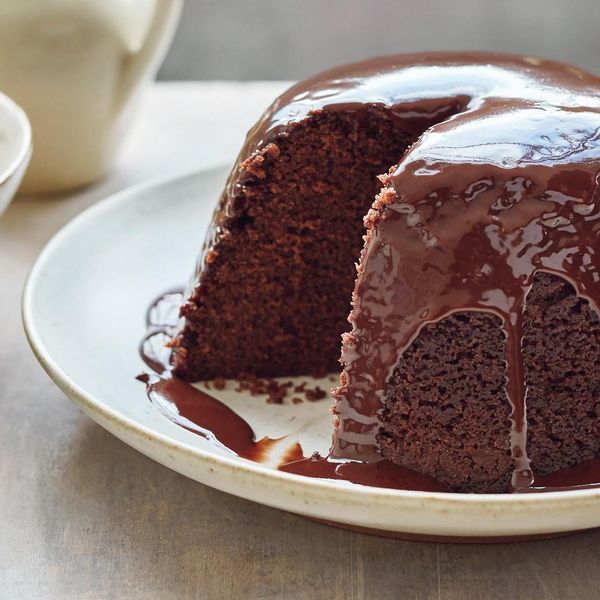 a chocolate cake on a plate with one slice cut out