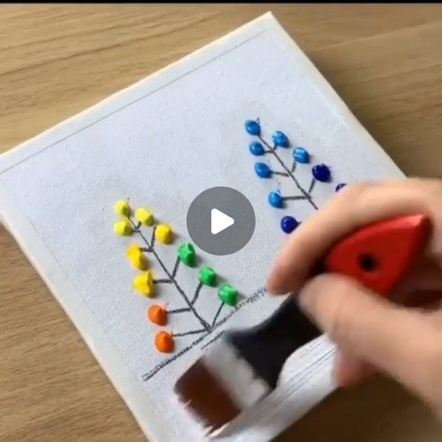 someone is using a marker to draw a family tree on a piece of white paper