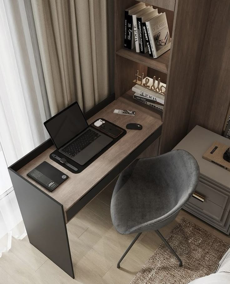 a laptop computer sitting on top of a wooden desk next to a chair and bookshelf