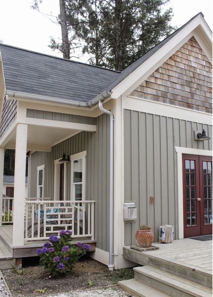 a small house with steps leading up to the front door