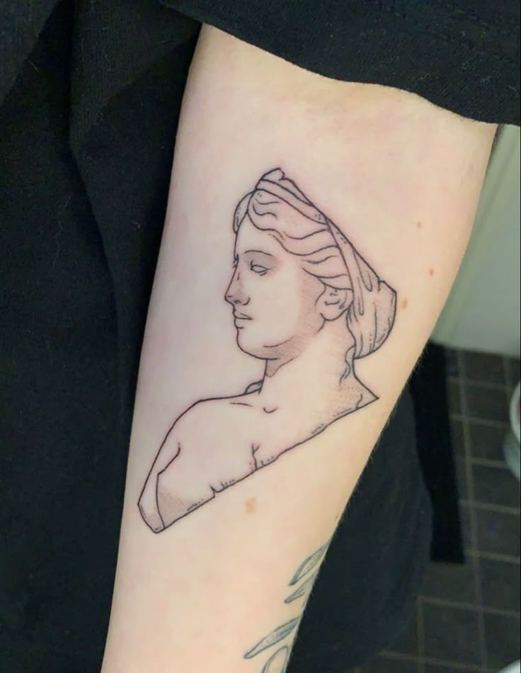 a woman's arm with a tattoo on it that has a portrait of a woman