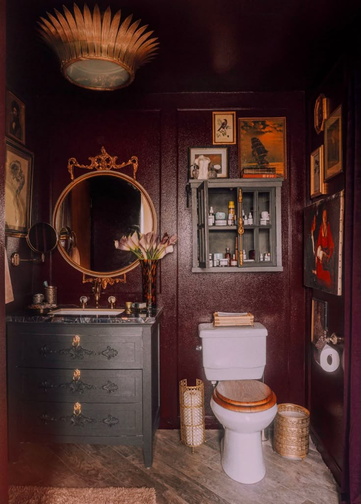 a bathroom with a toilet, sink and mirror in it's centerpieces