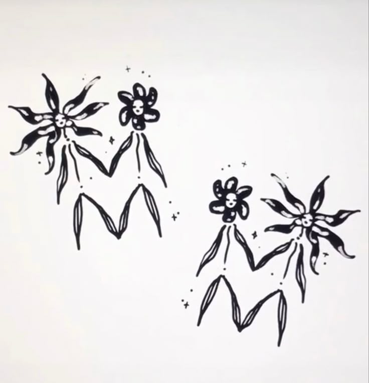 three black and white flowers on a white wall with stars in the sky behind them