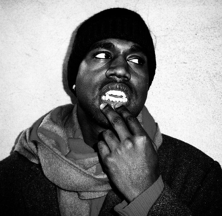 a black and white photo of a man brushing his teeth