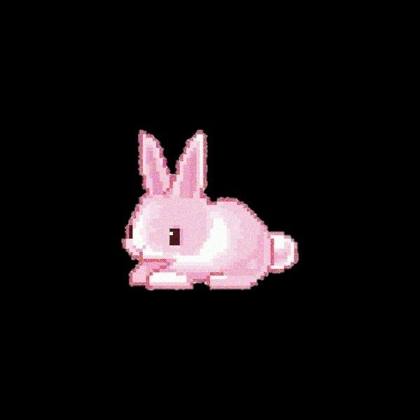 a pink rabbit sitting on top of a black background