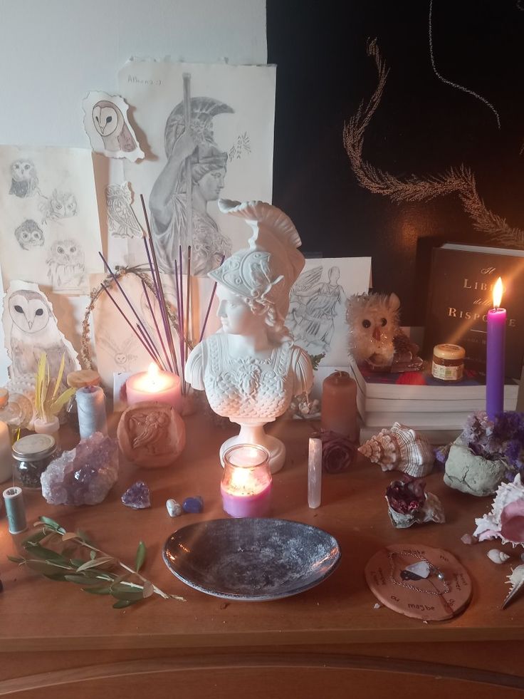 a wooden table topped with lots of candles and figurines on top of it