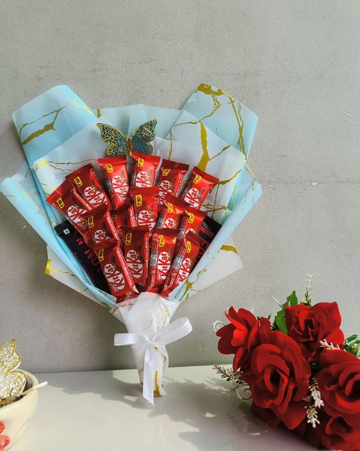 a bouquet of red roses and chocolate bars