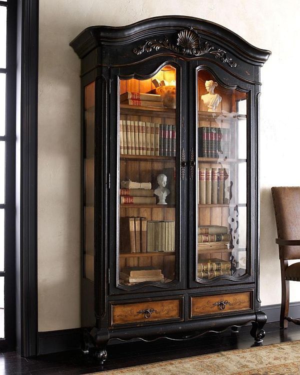 an old bookcase with glass doors and writing on it