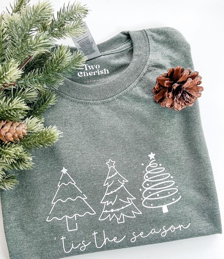 This T-shirt is made of 100% Cotton. Gildan Brand T-shirt  The design is made out of HTV ( Heat Transfer Vinyl) and applied with a heat press to secure design.  This listing is for one (1) 'tis the season with Christmas trees on T-shirt.  This T-shirt is perfect for the holiday/ Christmas season. Care Instructions: -Turn inside out and machine wash cold -Hang dry or tumble dry on low heat -Do not iron on design -Do not bleach **Keep in mind that monitors have different color settings, so the col Cricut Christmas Clothing, Happy Holidays Shirt, Holiday T Shirt Ideas, Christmas Htv Shirt Ideas, Christmas Shirt Cricut, Holiday Tshirts Ideas, Christmas Tree Shirt Ideas, Cricut Heat Press Projects, Christmas Vinyl Shirt Ideas