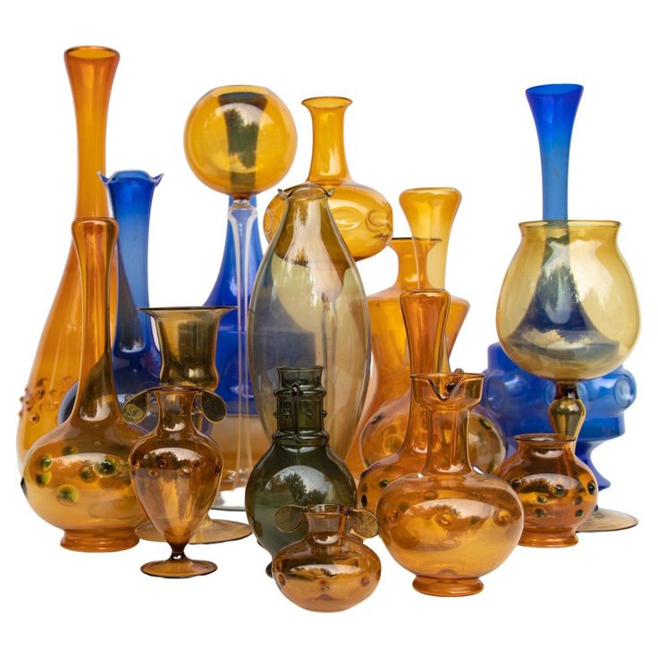 an assortment of glass vases are shown on a white background