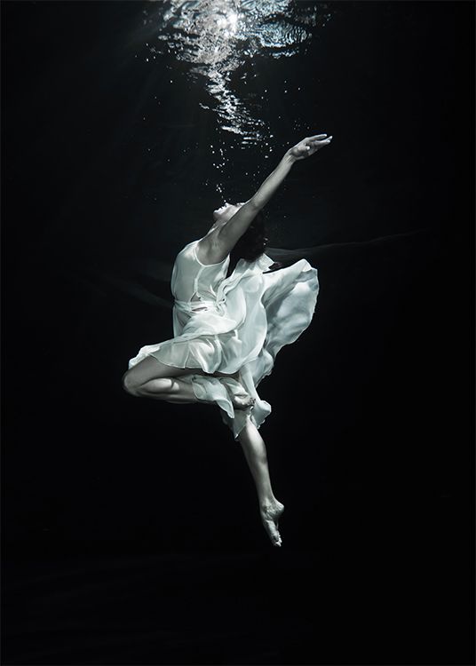 a woman in white dress floating under water