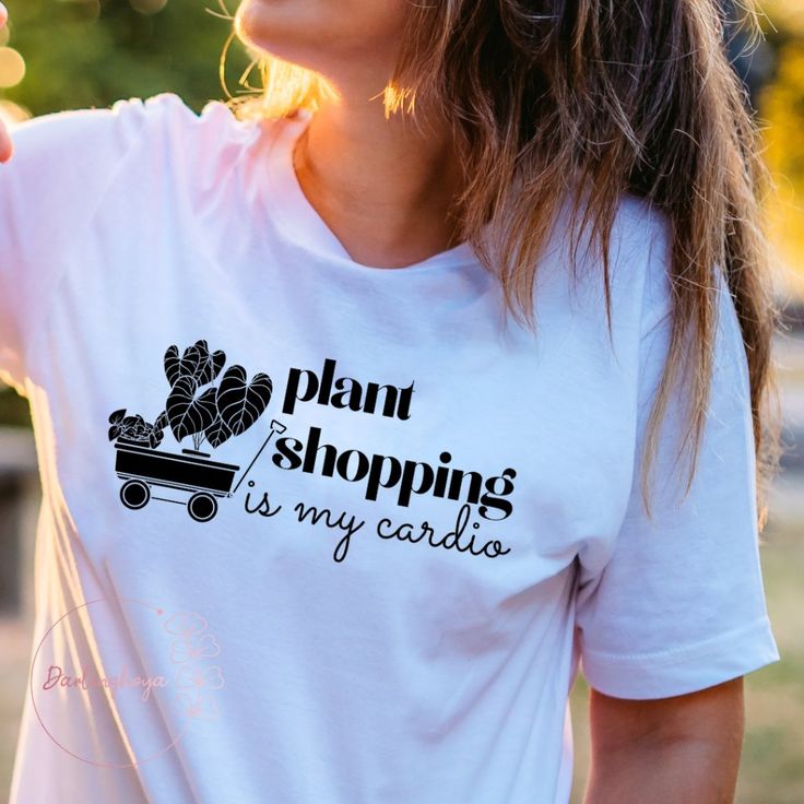 Who Needs Exercise When You Can Go Plant Shopping? Black Graphic On White Crew Neck T-Shirt. Materials And Care: - 100% Airlume Combed And Ring-Spun Cotton. - Side-Seamed. - Unisex Sizing. - Black Heat Transfer Vinyl Graphic. - Sustainably Produced. - Machine Washable. Trendy Cotton T-shirt With Plant Print, Plants Print Crew Neck T-shirt Gift, Plant Lover Tshirt, Stretch Lace Top, Short Sleeve T-shirt With Plants Print For Gardening, Plant Shopping, Green Plants Print T-shirt For Gardening, Tory Burch Ella, Plant Store