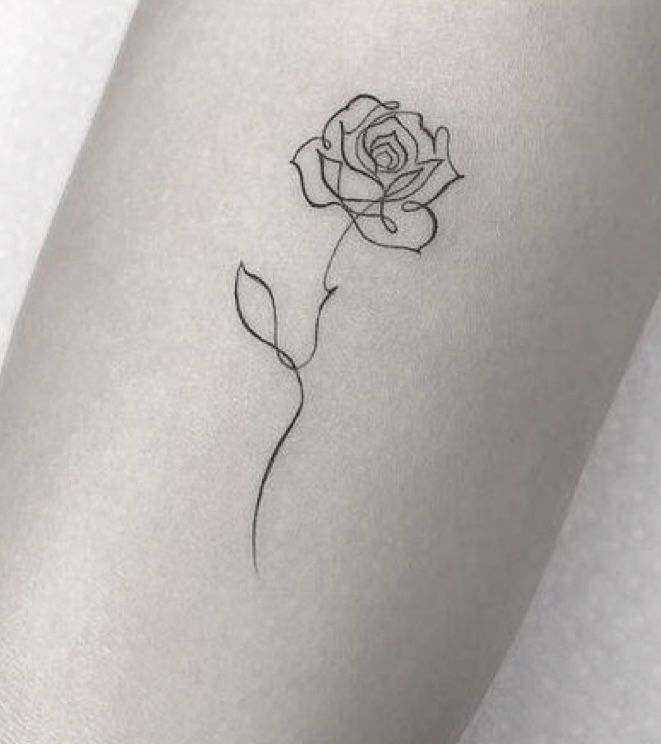 a single rose tattoo on the left arm and leg, with one flower in it's center