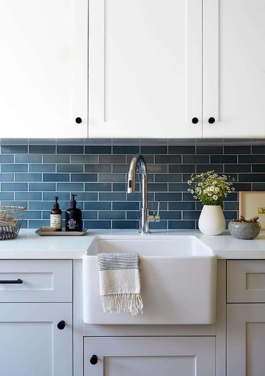 a white kitchen sink sitting under a faucet