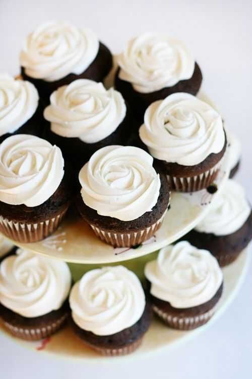 several cupcakes are stacked on top of each other with white frosting in the middle