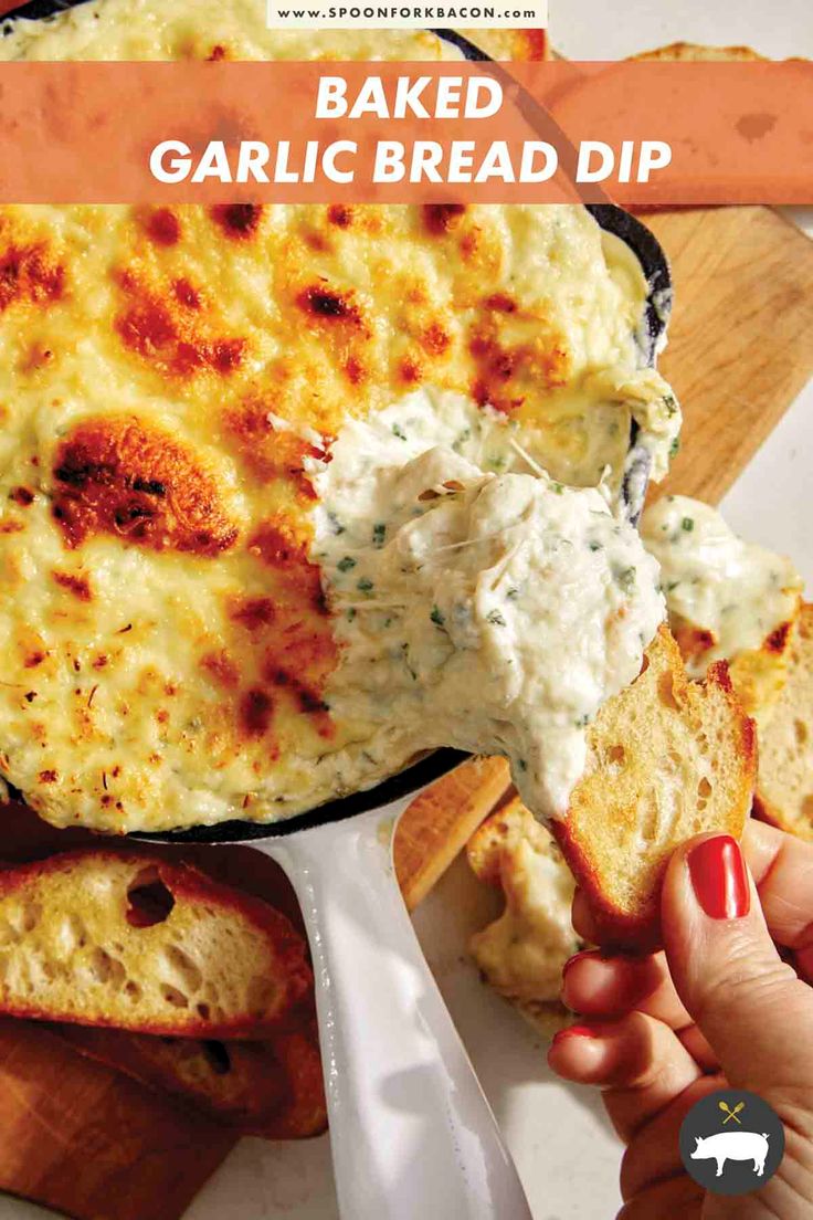 baked garlic bread dip in a cast iron skillet being held up by someone's hand