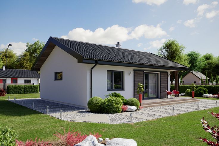 a small white house sitting on top of a lush green field