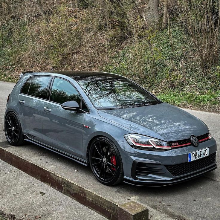 a grey car parked on the side of a road