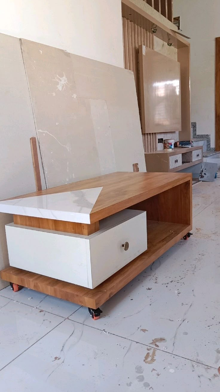 a white box sitting on top of a hard wood floor next to a wooden shelf