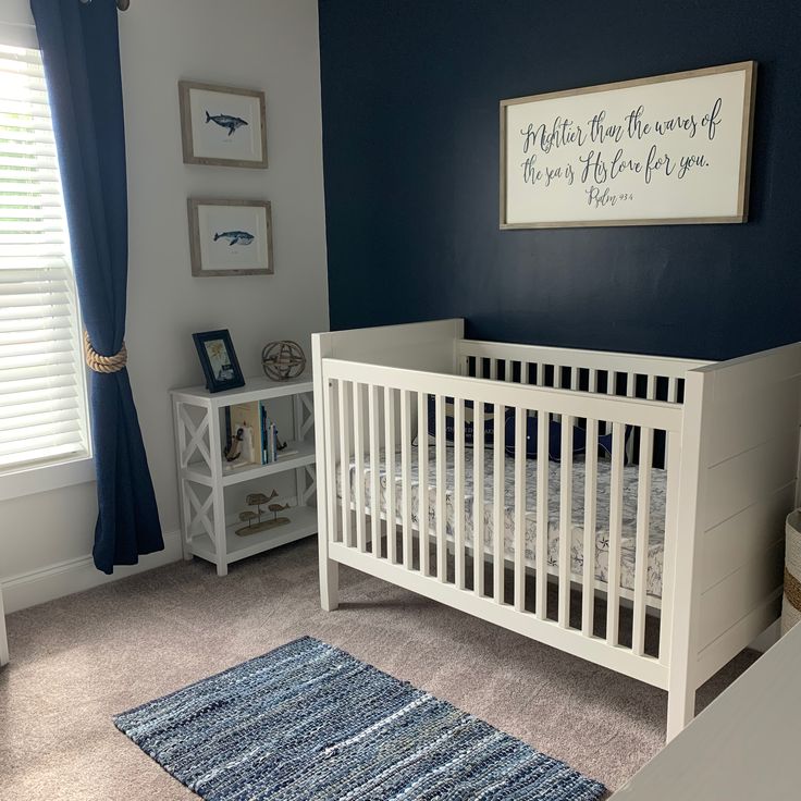 a baby's room with blue walls and white crib in the corner is shown