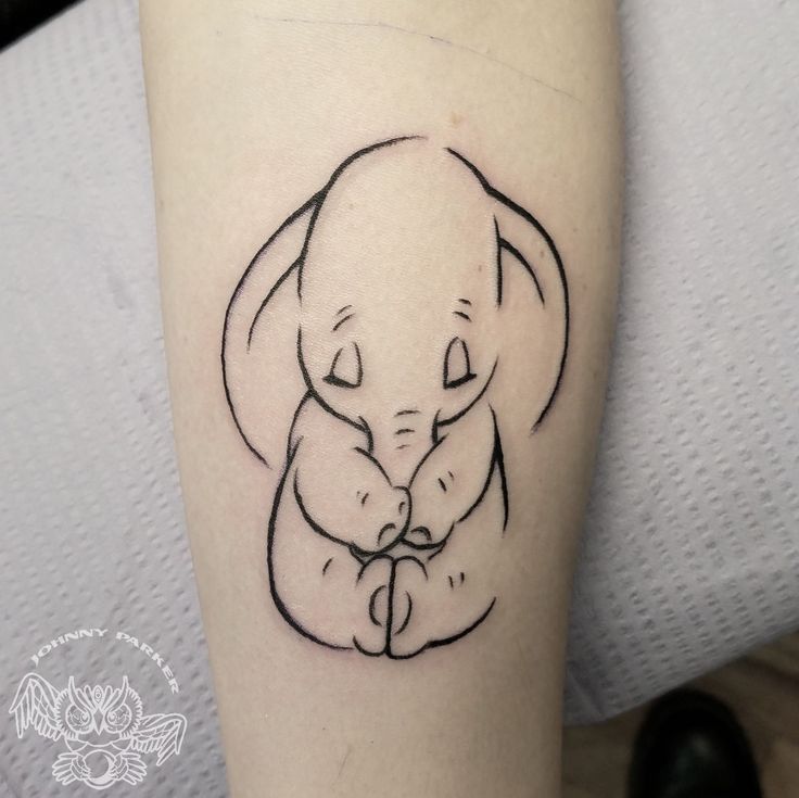 a small tattoo of an elephant holding its baby's hand with the word love on it