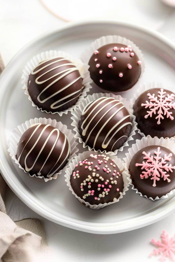 chocolates with white and pink sprinkles on a plate