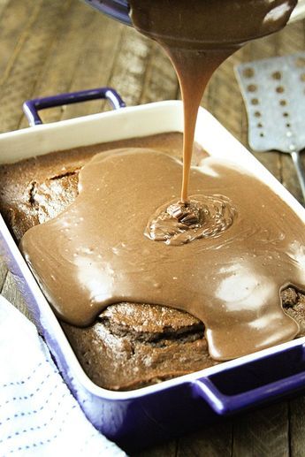 a pan filled with chocolate cake batter being drizzled on top of it