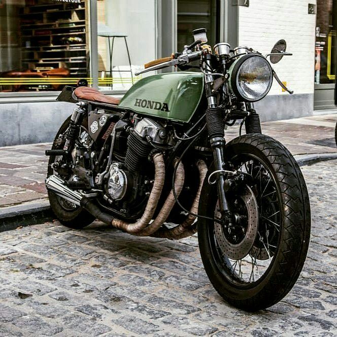 a green and black motorcycle parked on the street