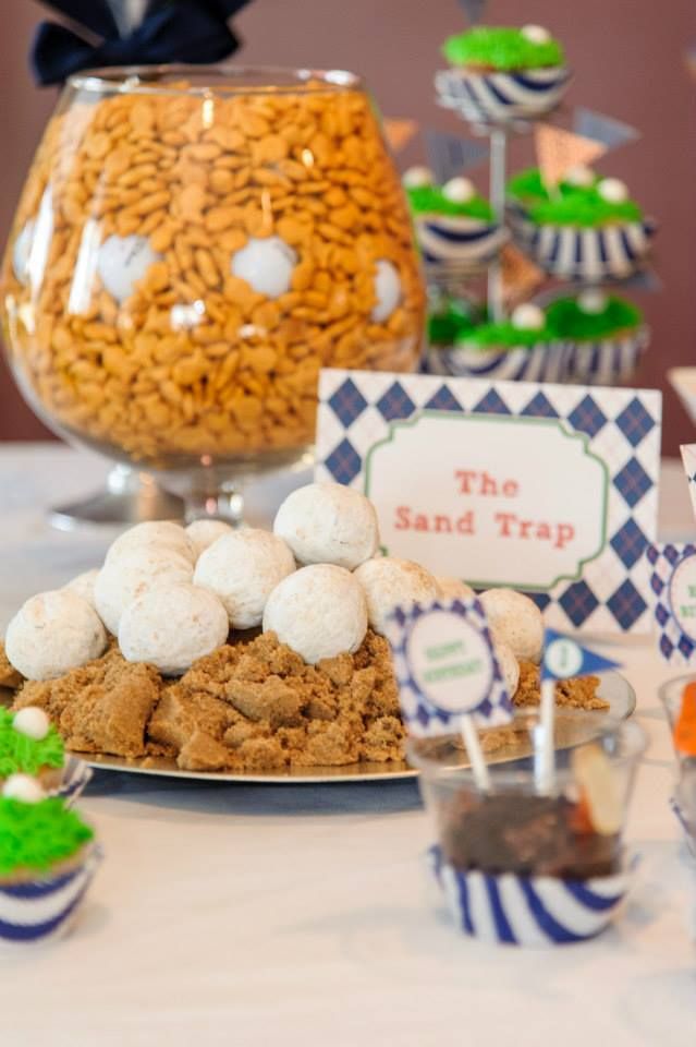 a table topped with lots of food and desserts next to a vase filled with candies