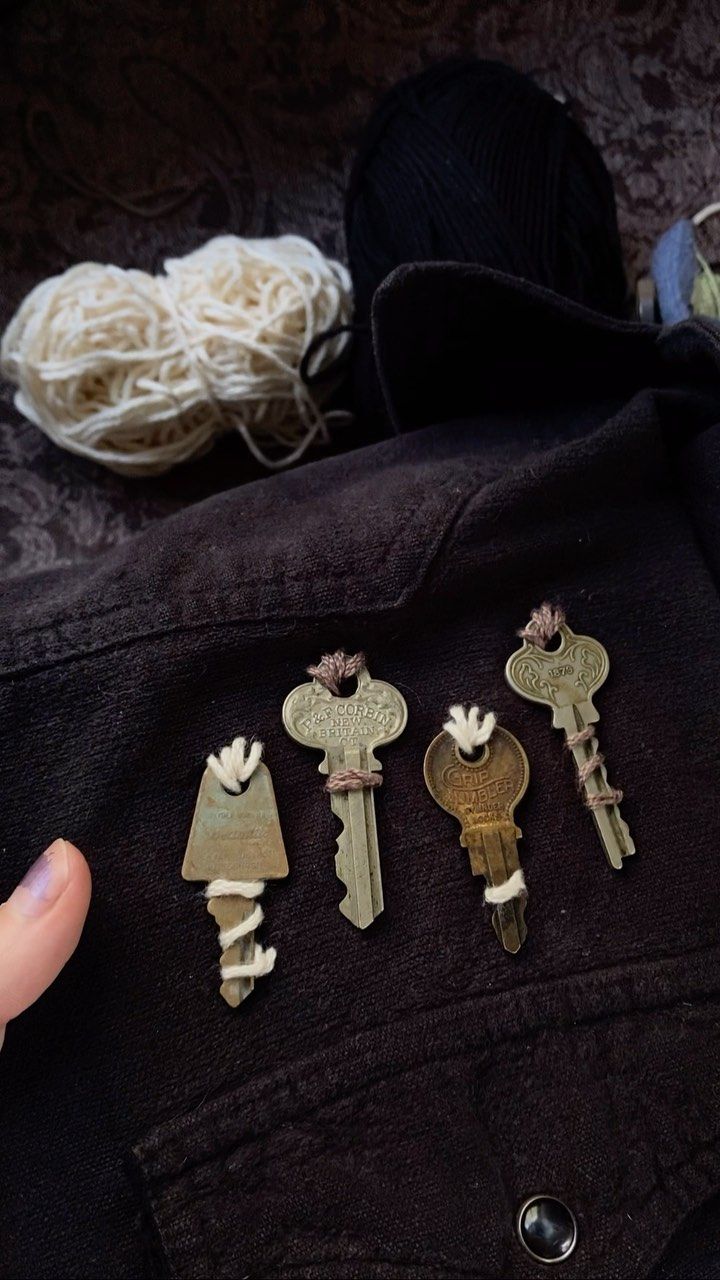 someone is holding some keys in their jacket