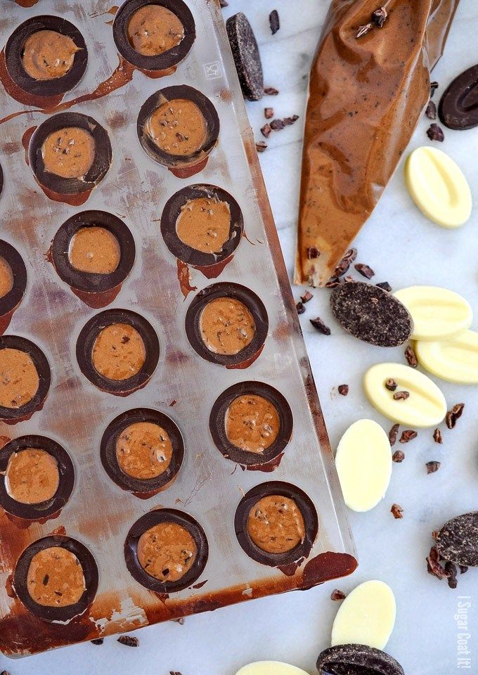 chocolate cupcakes are lined up on a baking sheet and ready to go into the oven