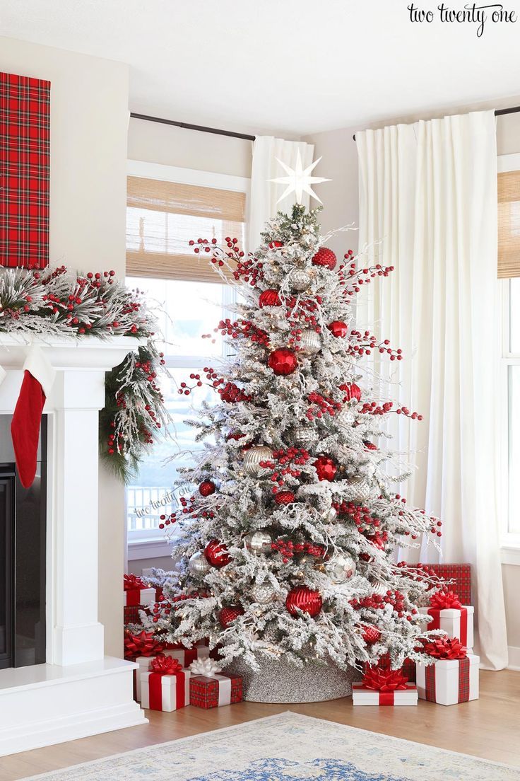 a white christmas tree with red and silver ornaments