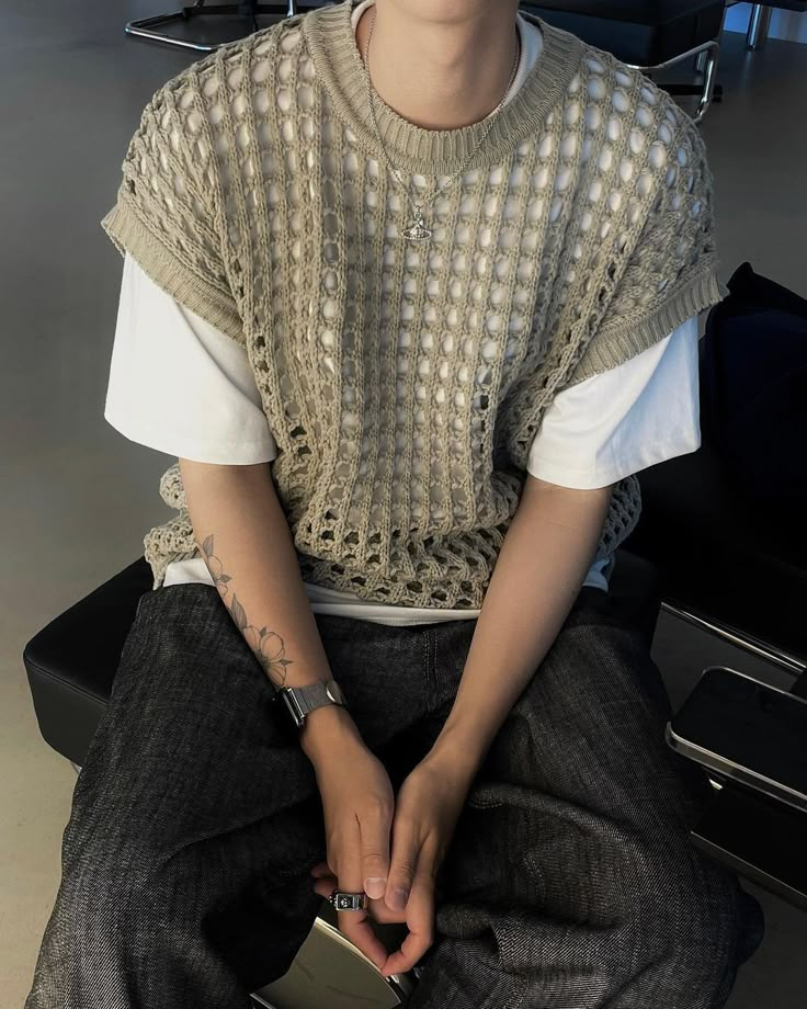 a young man sitting in an airport waiting for his luggage to be taken off the plane