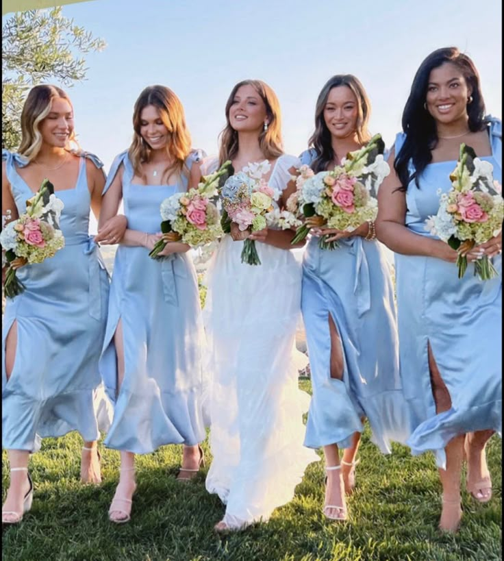 the bridesmaids are all dressed in blue dresses