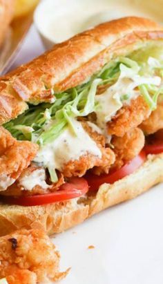 a chicken sandwich with lettuce and tomatoes