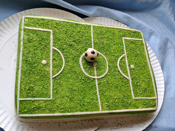 a cake decorated to look like a soccer field with a soccer ball on the grass