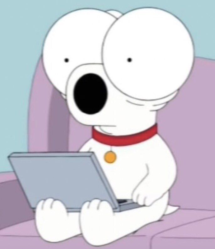 a cartoon dog sitting on a couch using a laptop