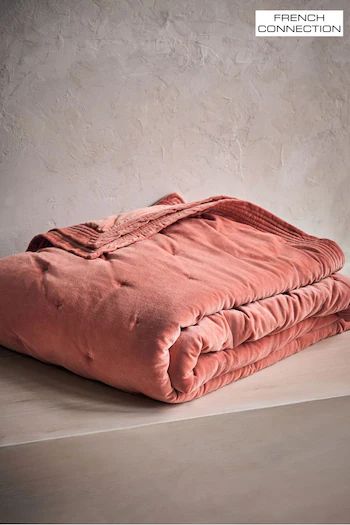 a pink blanket sitting on top of a table