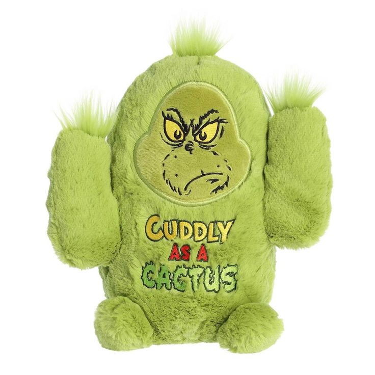 a green stuffed animal with the words cuddly is a grugus on it's chest