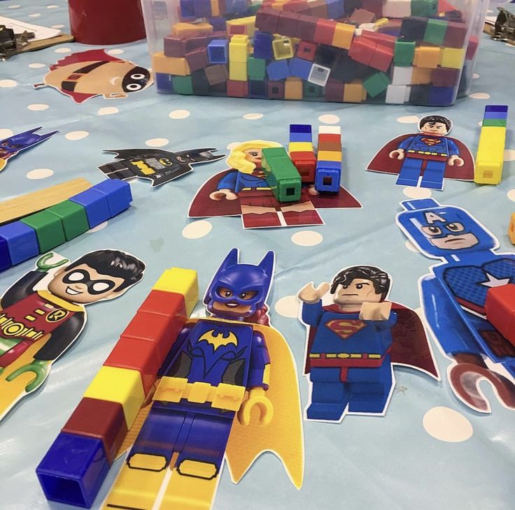 the lego batman party table is set up with toys