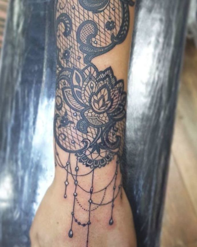 a tattoo on the foot of a person with an owl and dream catcher in it