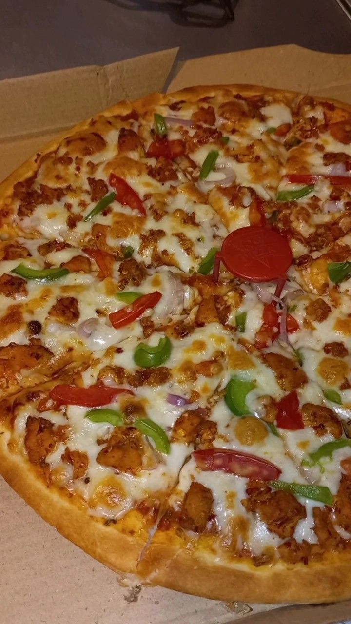 a pizza sitting on top of a cardboard box