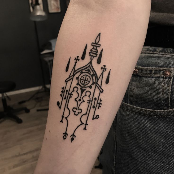 a black and white tattoo on the arm of a person with an arrow in it