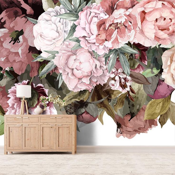 the wallpaper is decorated with pink flowers and leaves, along with a wooden chest