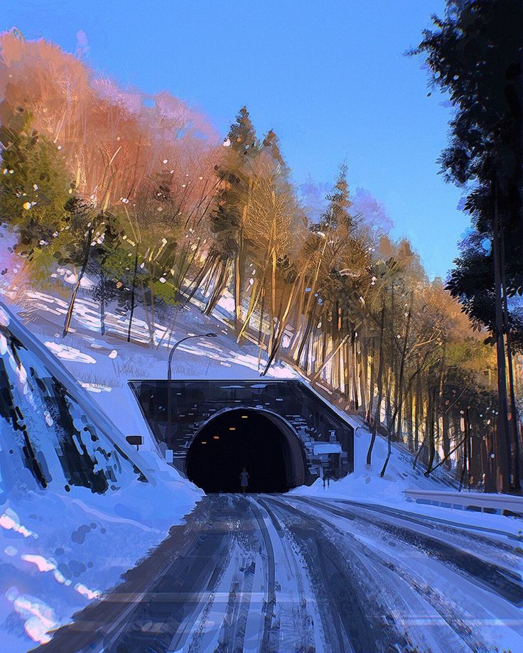 a snow covered road going into a tunnel with trees on both sides and the light at the end