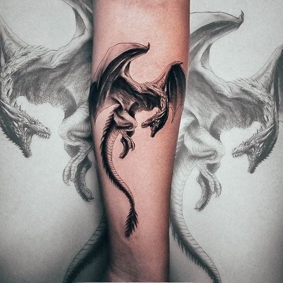 a dragon tattoo on the leg of a person