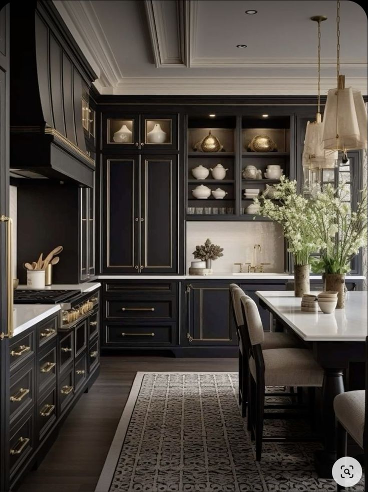 a large kitchen with black cabinets and white counter tops, along with an area rug on the floor